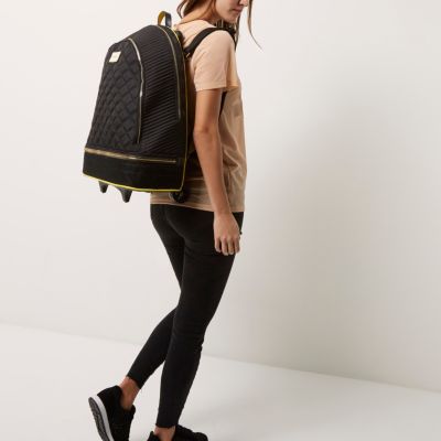 Black quilted backpack on wheels